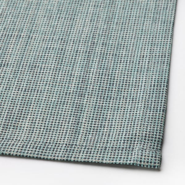 Close-up of woven green-blue cotton tablecloth, showcasing intricate texture and quality craftsmanship.