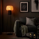 SYMFONISK wi-fi lamp: floor lamp with bamboo shade, black base, beside gray couch.