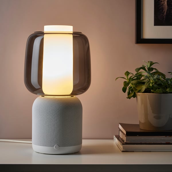 Modern wifi speaker lamp with plant and books on desk - ikea & sonos collaboration.