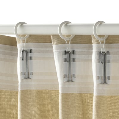 Three beige curtains hang from white rod using clips and hooks on rings.