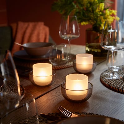 Set of 2 TALLTITA glass tealight holders, one grey, one white, round shape, simple design.