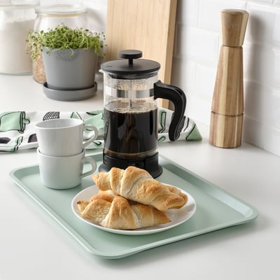 Green tray with pastries, coffee & plunger, indoor/outdoor, dishwasher safe. Or green pastry tray with coffee & plunger, dishwasher safe.