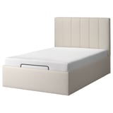 Minimalist bed with a beige headboard and upholstered frame, featuring a modern design.