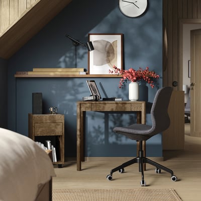 Modern home office with TONSTAD desk, chair, laptop, flowers, lamp, wall art - perfect for small spaces.