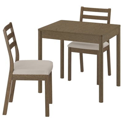 A TONSTAD dining set with a light brown wood table and matching chairs, one with a cushion.