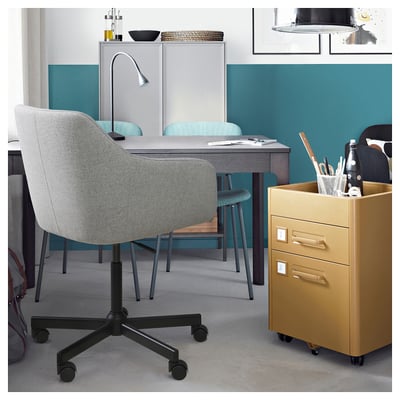 Modern office with TOSSBERG chair, desk, filing cabinet, and supplies.