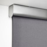 Close-up of modern roller blind with block-out fabric, demonstrating cordless and soft-closing.