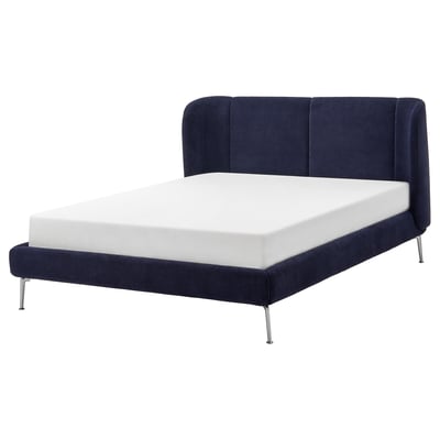 Modern blue bed with curved headboard, upholstered in fabric, featuring chrome legs.