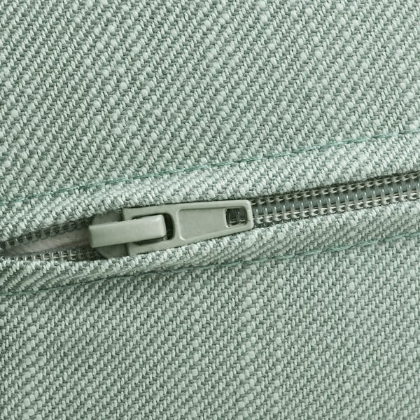 Close-up of light green cushioned zipper, showcasing quality fabric and sturdy pull.