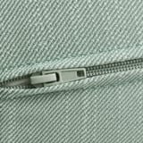 Close-up of light green cushioned zipper, showcasing quality fabric and sturdy pull.