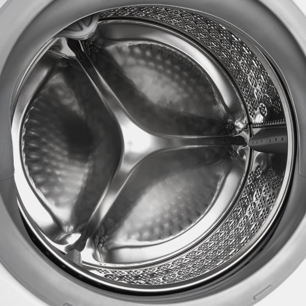 Washing machine drum with water flow showing. Designed for efficient, adjustable washing with steam program and various settings.