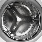 Washing machine drum with water flow showing. Designed for efficient, adjustable washing with steam program and various settings.
