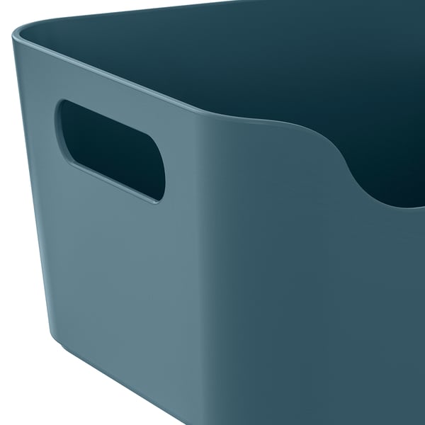 A large, teal storage bin with handles, smooth texture, and rounded corners.