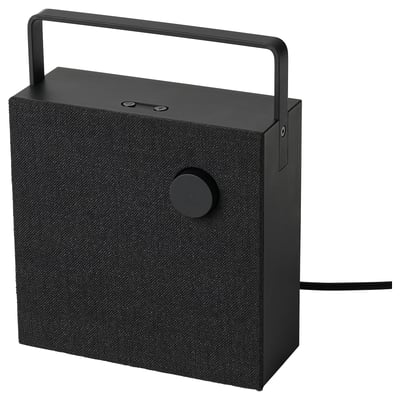 Black portable bluetooth speaker with a handle, circular control button, and fabric cover.