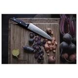 Wooden cutting board with assorted chopped colorful veggies and a silver knife, VARDAGEN brand.