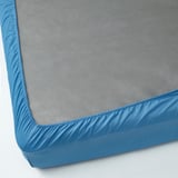 A fitted blue bed sheet, elastic edges ensure snug fit.