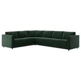 A VIMLE corner sofa in green velvet, featuring a deep, plush design with a soft, reflective shine.