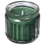 Green candle in clear glass jar with ribbed design, white wick.