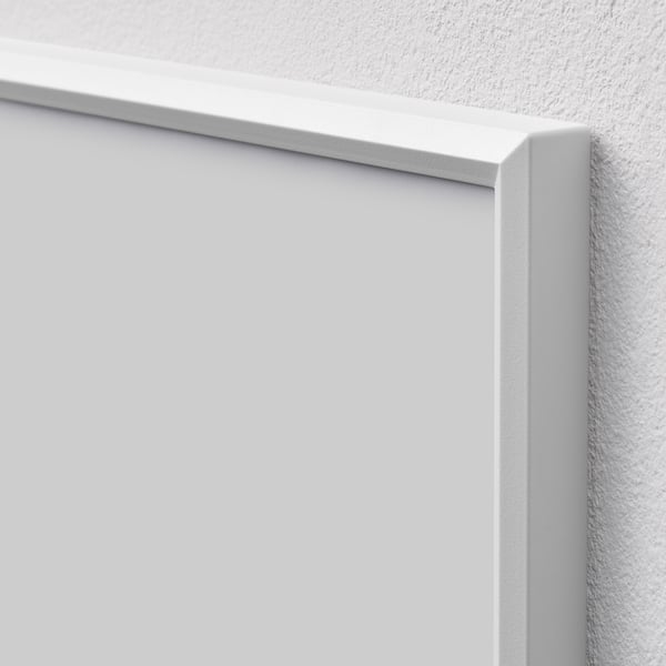 Close-up of minimalist white picture frame corner, showcasing sleek design and high-quality finish.