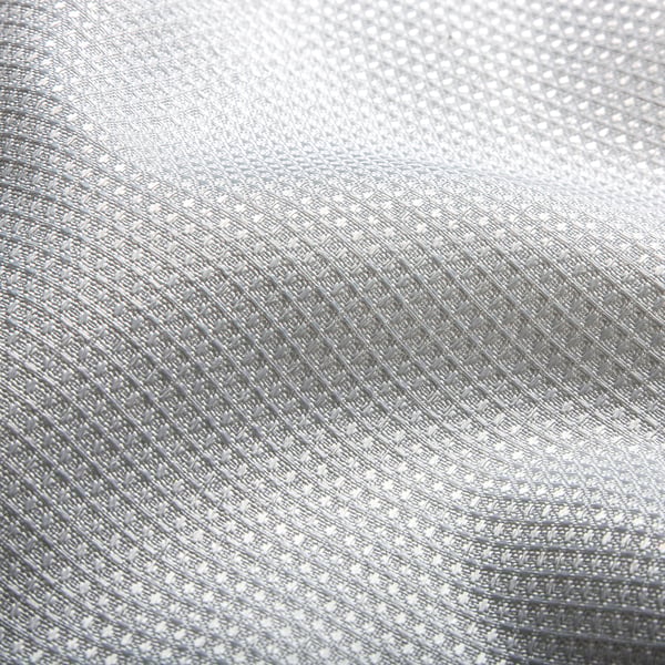 Close-up de tecido elegante e repelente de água com textura de waffle 3D, mostrando padrões sutis e superfície lisa.