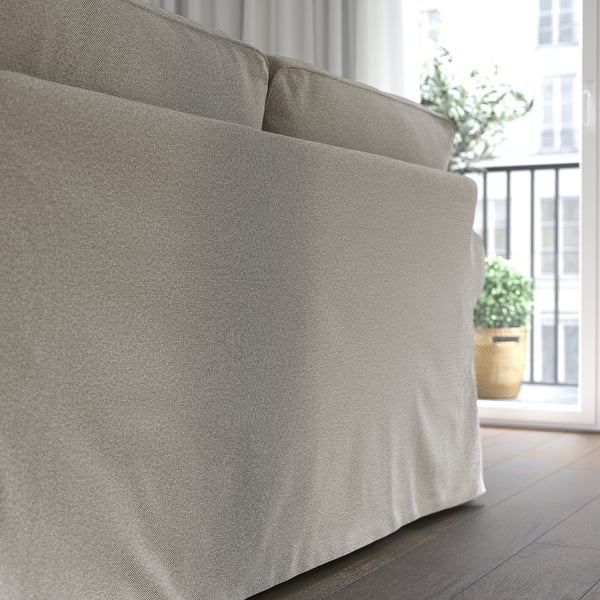 Um sofá EKTORP aconchegante mostrado na parte de trás, oferecendo uma almofada espessa para maior conforto. Capa de chenille cinza claro com uma superfície macia e levemente reflexiva.