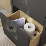 Armário de banheiro aberto com papéis higiênicos e lenços de papel.