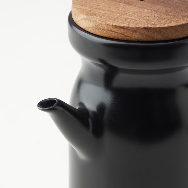Frasco de cerâmica preta com tampa de madeira, design elegante, acabamento liso, bico funcional.