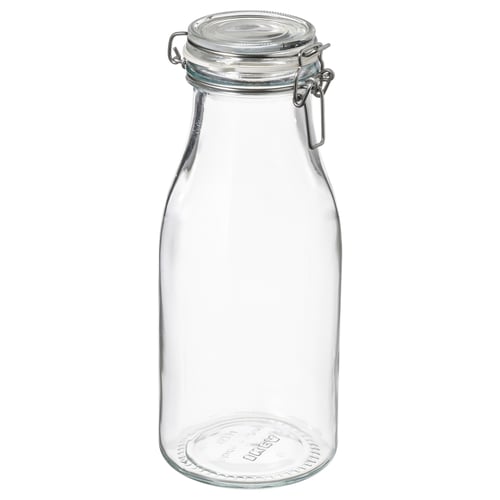 Frasco de vidro transparente com tampa de grampo de metal, ideal para armazenamento de alimentos. Transparente, cilíndrico com fundo plano.