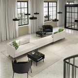 Sala de estar moderna com sofá LILLEHEM branco, cadeiras pretas, mesas de centro e luminárias pendentes pretas. Grandes janelas com cortinas brancas.