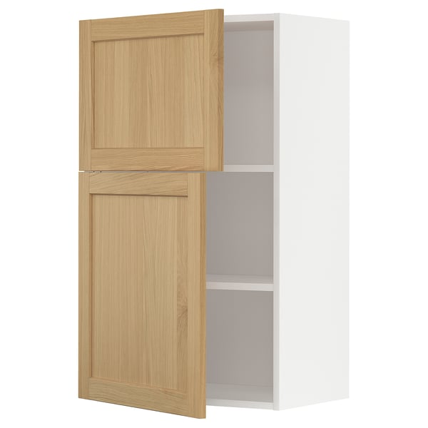 Um armário de cozinha de parede com portas de madeira clara e interior branco, parte do sistema METOD.