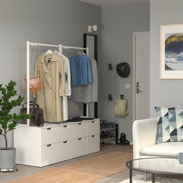 Sala de estar moderna com cômoda, cadeira, planta e decoração NORDLI.