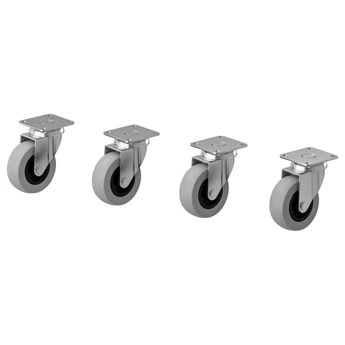 Quatro rodízios RILL cinzentos, dois com travões, suportes metálicos, rodas circulares com degraus de borracha, concebidos para facilitar a movimentação dos móveis.