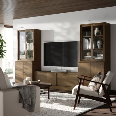 Sala de estar moderna: tv, armários de madeira, livros, cadeiras, tapete cinza.
