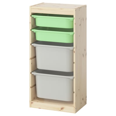 Uma unidade de arrumação em madeira TROFAST da ikea com caixas de plástico verde e branca, ideal para organizar brinquedos para crianças.