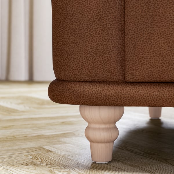 Fundo do sofá com textura castanha com perna de madeira, design clássico.