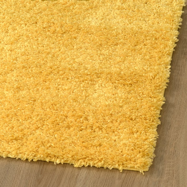 Bright yellow, soft, shaggy area rug, thick pile, feels cosy and warm, ideal for living room or bedroom.