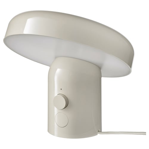 A white BLOMPRAKT lamp with a round shape and a unique design. It has a dimmable light and modern controls on the base.