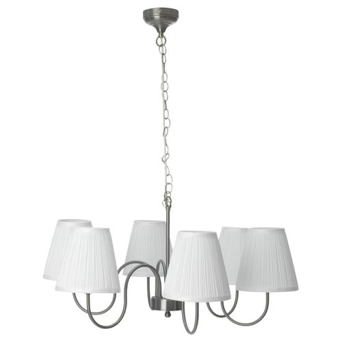 Displays a nickel-plated chandelier with five pleated white shades, suspending from a chain.