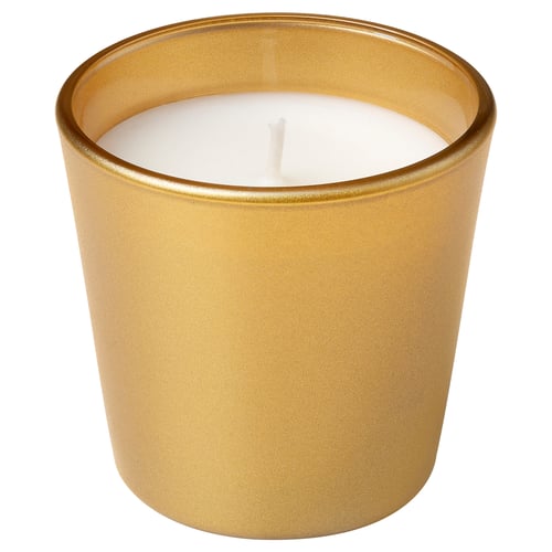Golden cylindrical candle jar with white wax and cotton wick, sits alone against white.