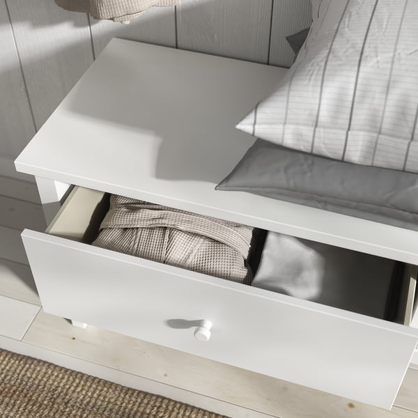 White GULLABERG storage bench. Minimalist design with two open drawers filled with folded blankets. Clean lines, robust, traditional look.