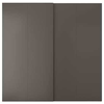 A dark grey HASVIK sliding door, sleek and minimalist, made of abs plastic and fiberboard, matching pax frames perfectly.