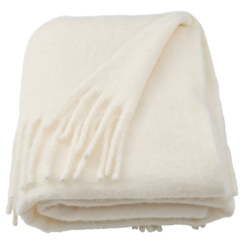 This image shows a KLIPPOXEL off-white recycled polyester throw blanket, soft, with a fluffy surface and fringed edges.