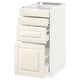 White METOD kitchen cabinet with three drawers and door, off-white fronts, bevelled edges.