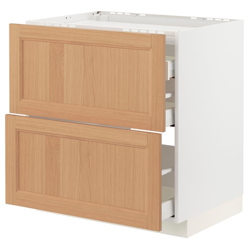 A METOD kitchen cabinet with oak drawers and a white base. It has a sleek, modern design with a light wood finish and several pull-out drawers.