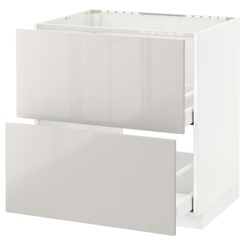 Modern white kitchen cabinet with open drawers, glossy finish.