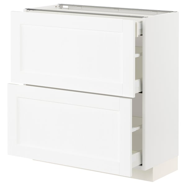 White METOD kitchen cabinet, flat panel design, with partially open drawers.