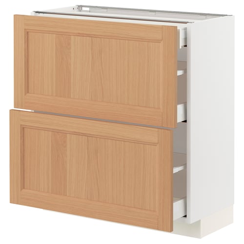 A light wooden METOD kitchen cabinet with drawers. The natural oak finish and sleek white edges give it a modern look.