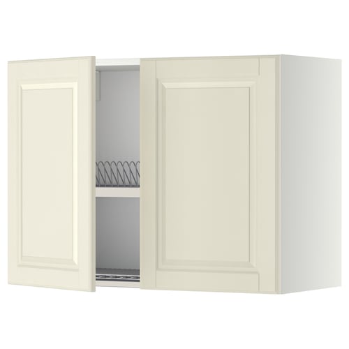 An off-white METOD kitchen wall cabinet with bevelled edges and an open door revealing an adjustable shelf and a steel dish drainer.