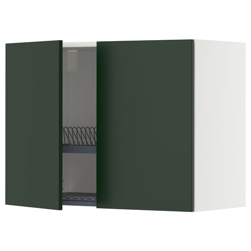Modern dark green kitchen cabinet with one open door showing an adjustable shelf and a metal dish drainer.