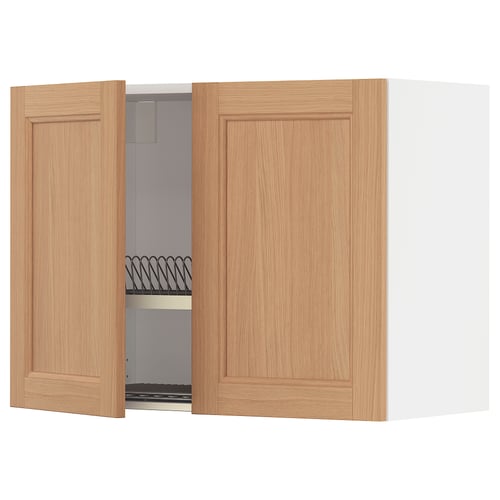 METOD kitchen cabinet in oak. Two wooden doors, one open displaying shelves and dish drainer.
